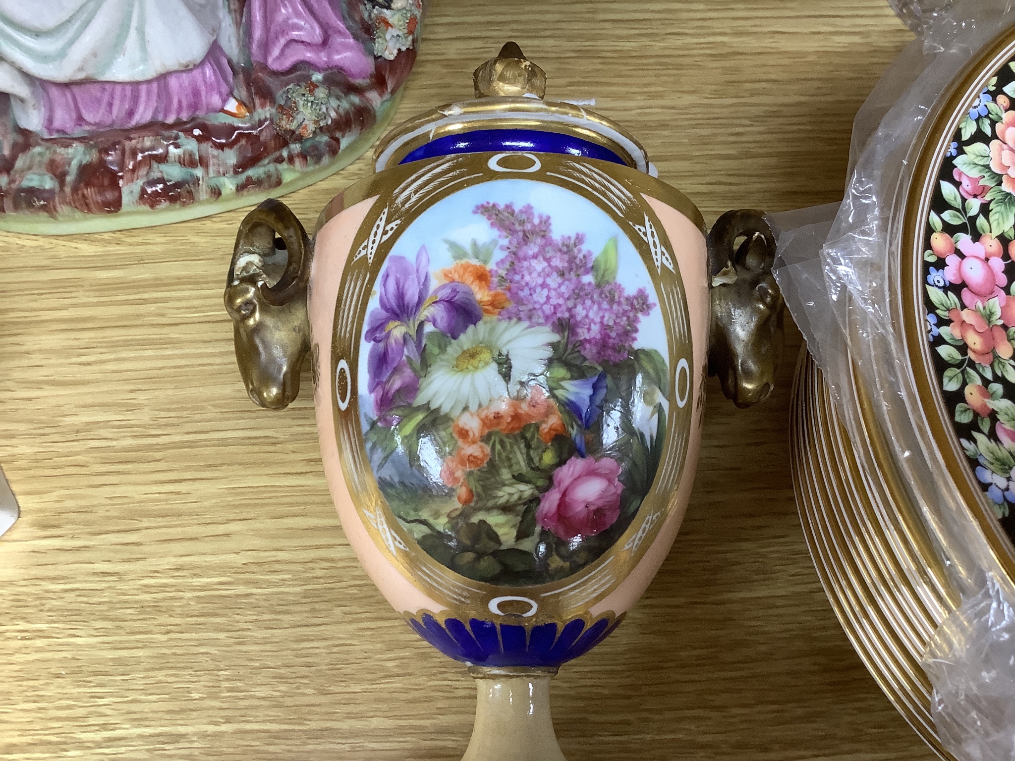 An early 19th century Derby vase, associated cover, a Staffordshire seated gentleman and an arbour group, tallest 25cm